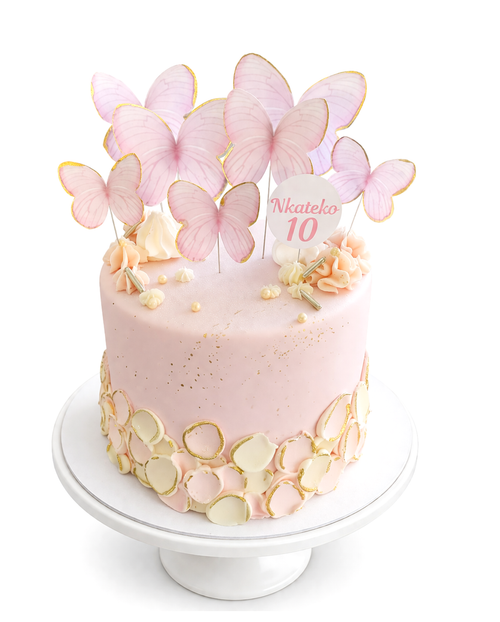 Butterfly themed blush pink cake with gold accents and delicate butterfly decorations finished in white chocolate ganache on white cake stand