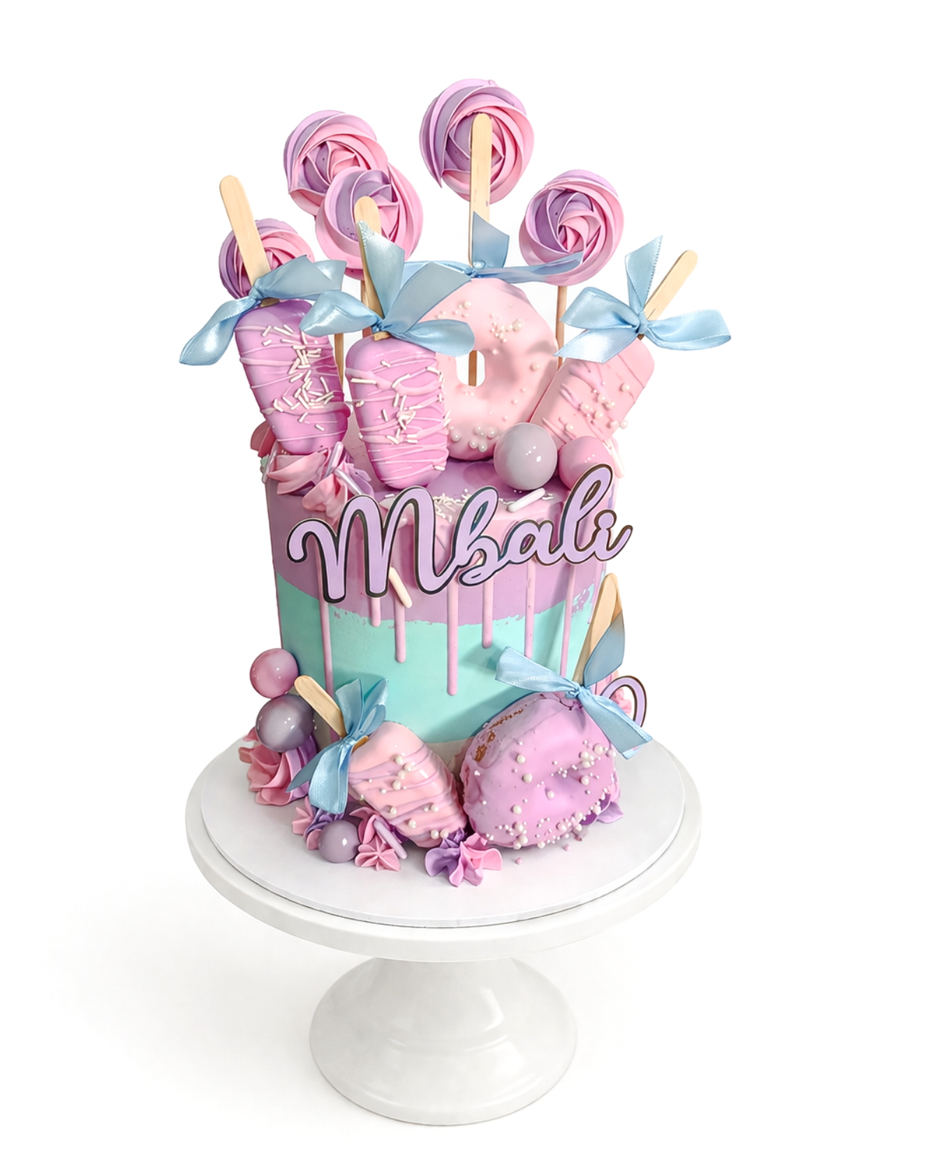 Colourful candy themed cake with pastel tones, dripping icing and sweet decorations finished in white chocolate ganache on white cake stand
