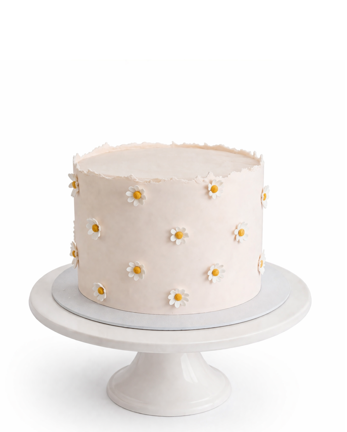 Minimalist daisy cake with small white floral details and smooth white chocolate ganache finish on white cake stand
