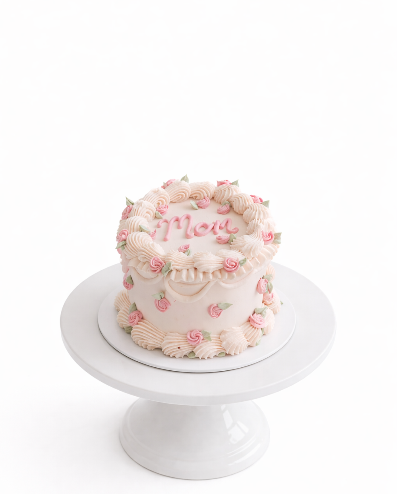 Vintage style blush pink cake with piped detailing and smooth white chocolate ganache finish on white cake stand