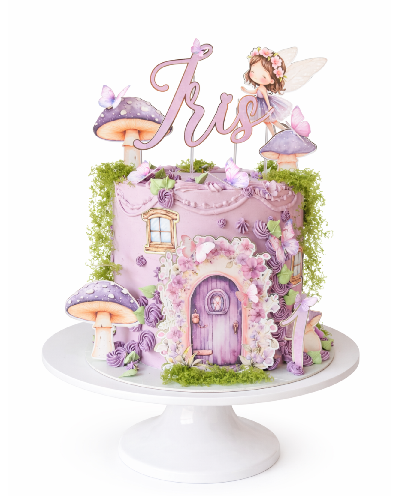 Fairy themed birthday cake with purple tones, butterflies, mushrooms and storybook cottage design with custom name topper on white cake stand