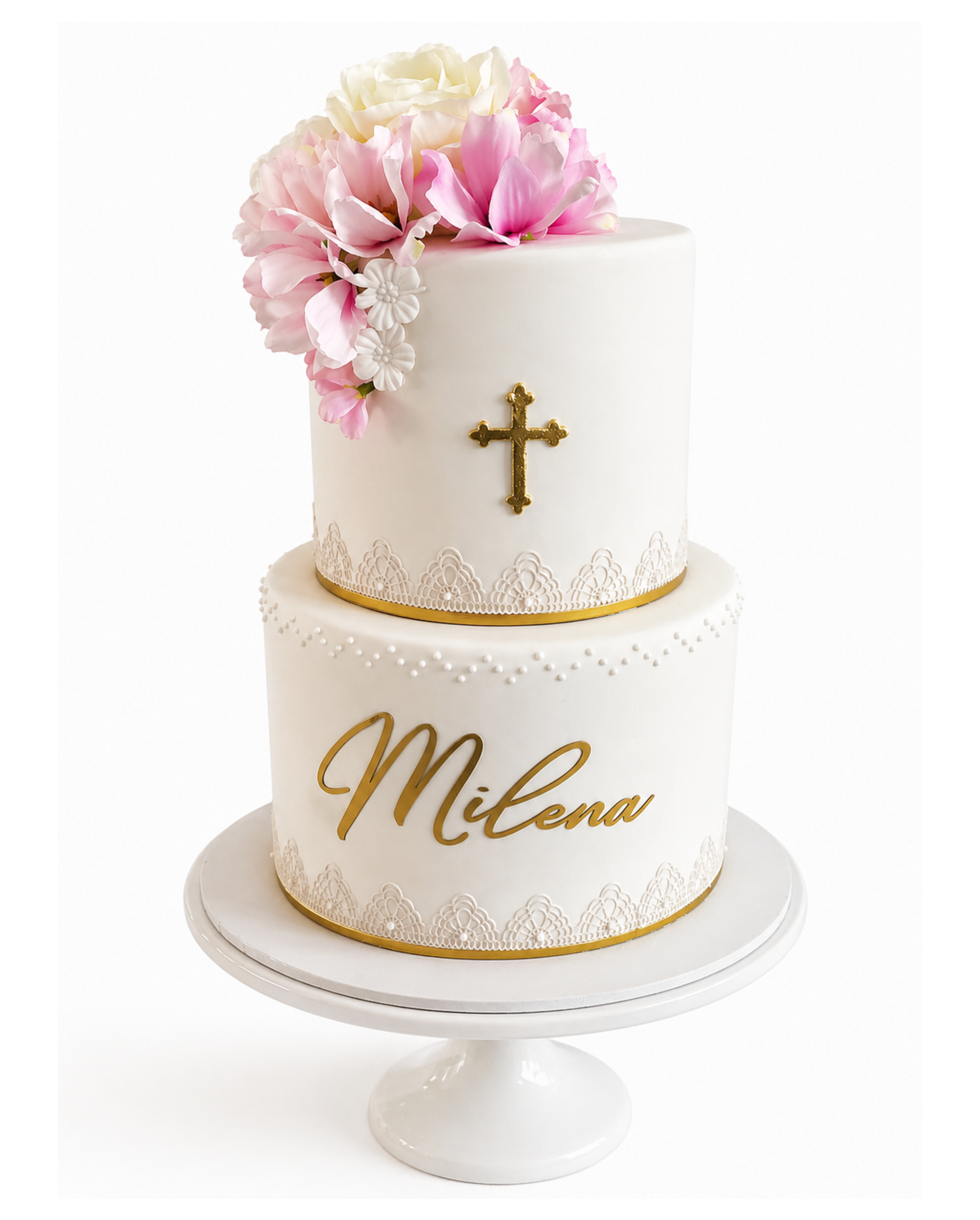 Two-tier ivory fondant cake with blush and white sugar flowers, gold cross detail, lace accents, and personalised gold script on a white cake stand.