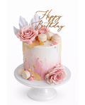 Elegant pink floral cake with gold leaf detailing, macarons and rose decorations finished in white chocolate ganache on white cake stand