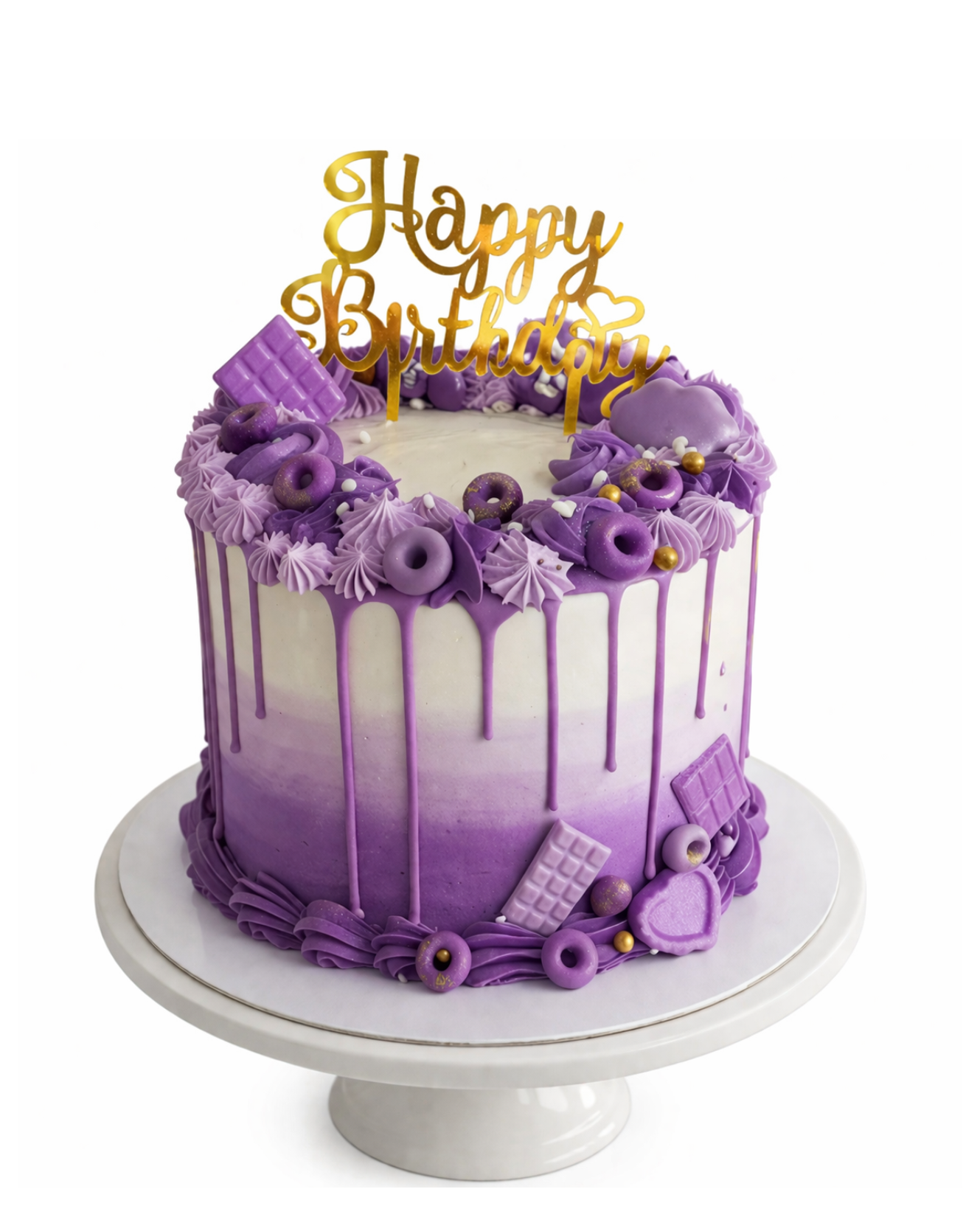 Purple ombre drip cake with piped swirls and gold topper finished in white chocolate ganache on white cake stand